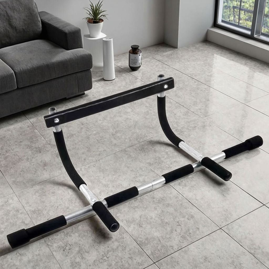 Gymnastic exercise bar on a tiled floor with a couch and plant in the background